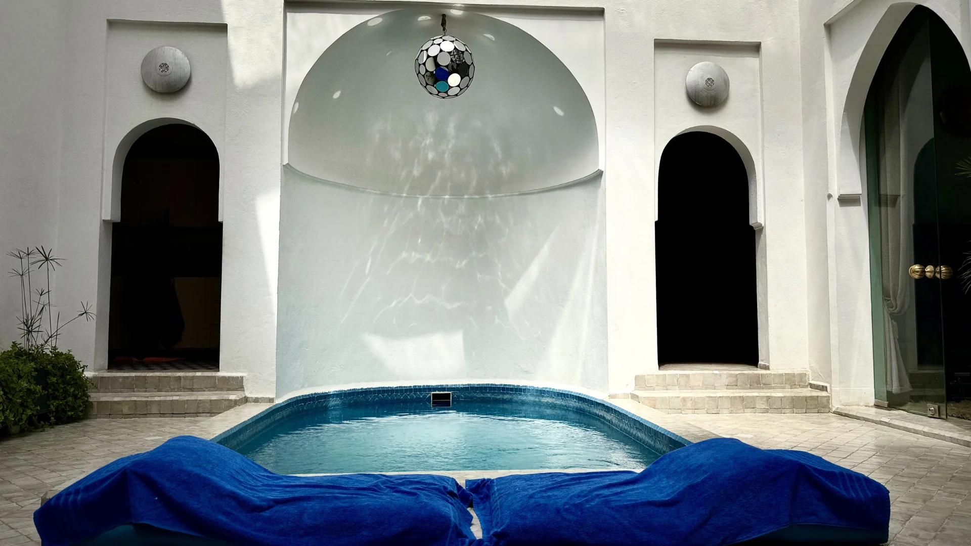 Dar Maureen's private open-air pool with arched Moorish ceiling and star lantern